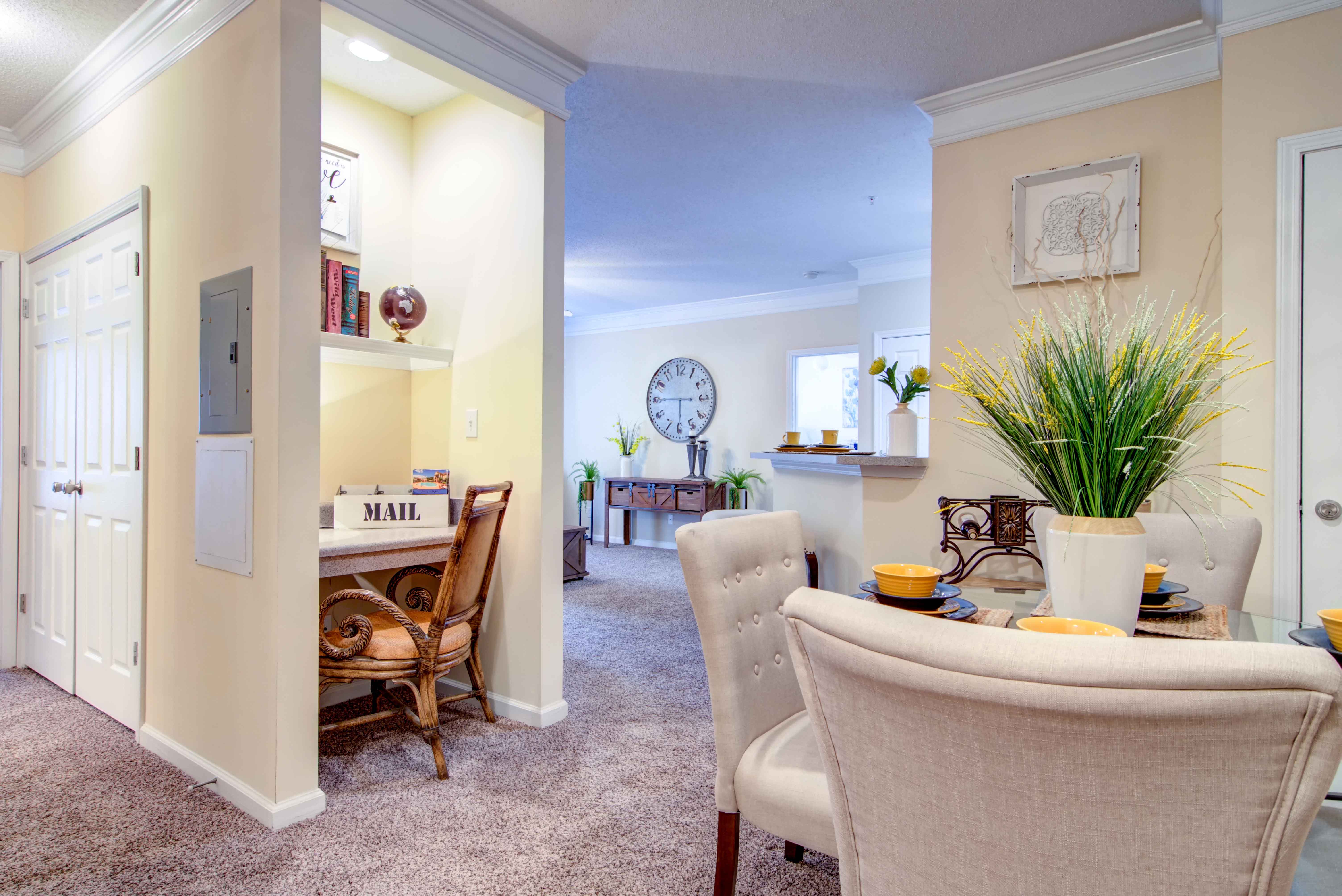 a living room and dining room with a table and chairs